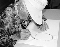 Elderly woman drawing in art workshop
