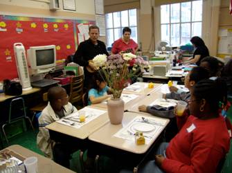 Students around a table with flower vase in center